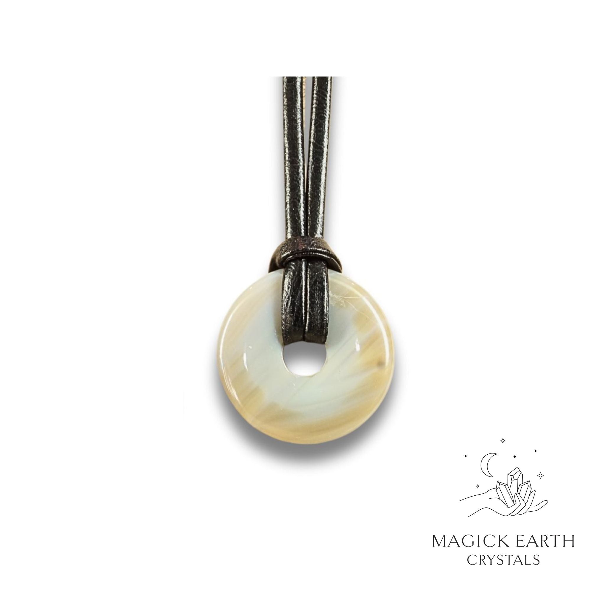 Natural 30mm agate donut pendant hanging from a black vegan cord.