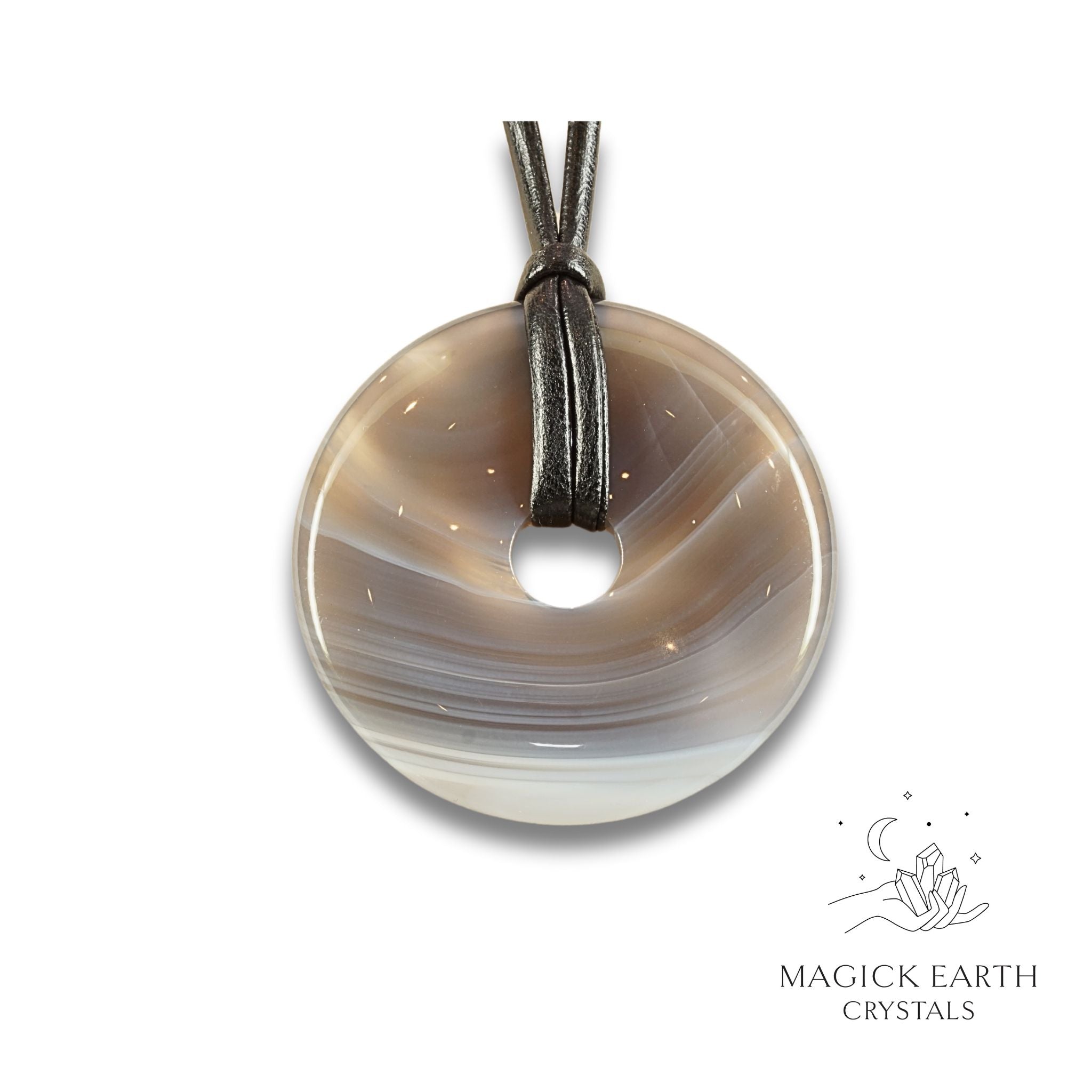 Natural 50mm agate donut pendant hanging from a black vegan cord.