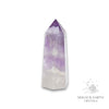Amethyst crystal tower on a white background with 'Magick Earth Crystals' logo for Sacred Stillness