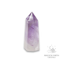 Amethyst crystal tower on a white background with 'Magick Earth Crystals' logo for Sacred Stillness