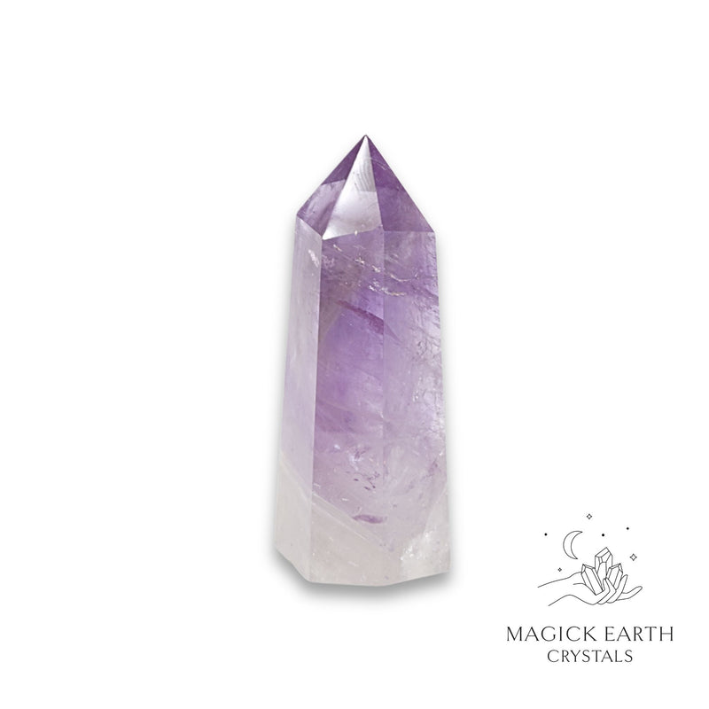 Amethyst crystal tower on a white background with 'Magick Earth Crystals' logo for Sacred Stillness