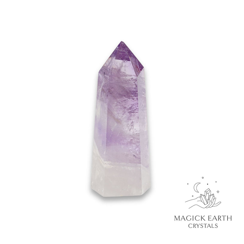 Amethyst crystal tower on a white background with 'Magick Earth Crystals' logo for Sacred Stillness