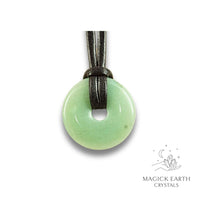 Natural 30mm aventurine donut pendant hanging from a black vegan cord.