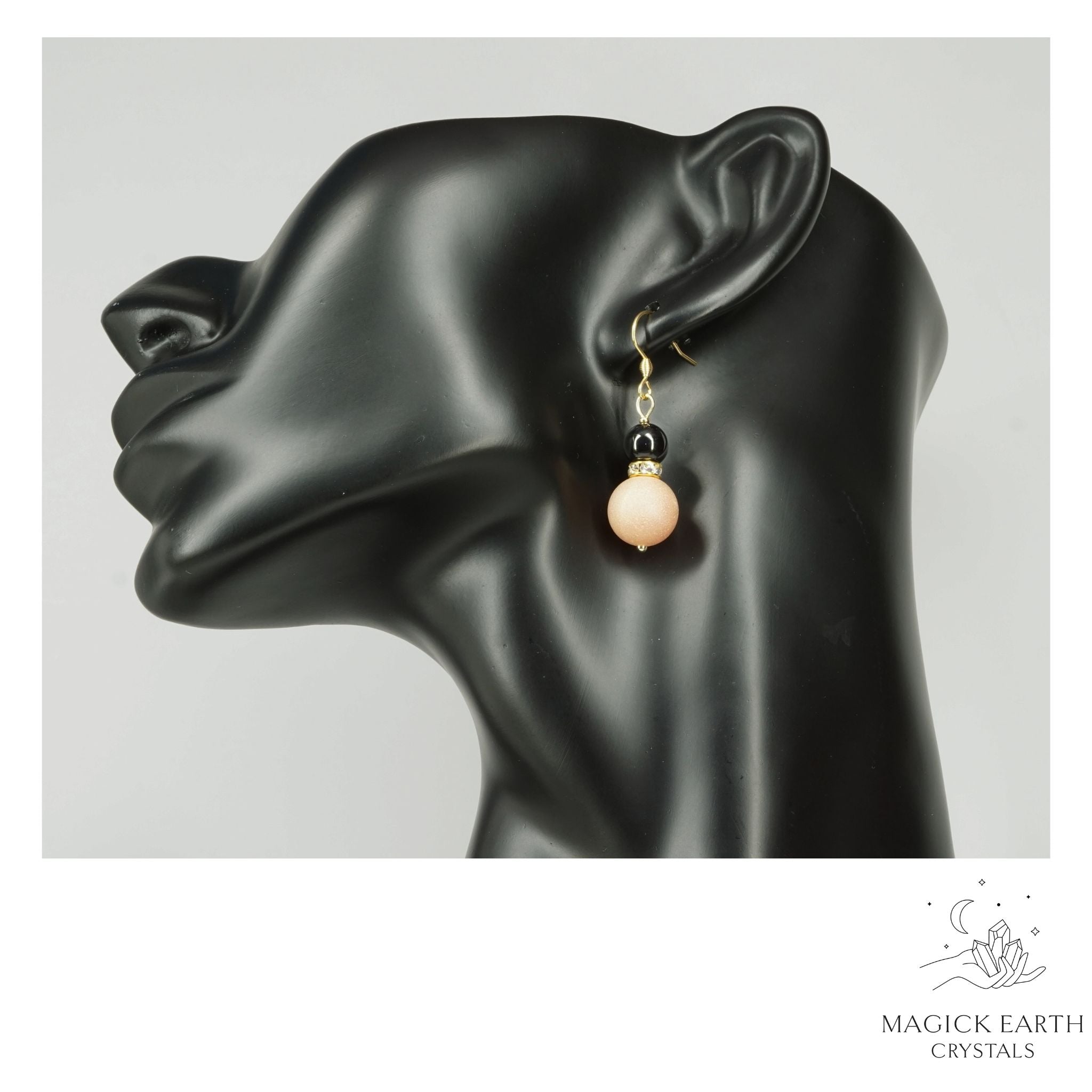 Beige Electroplated Druzy Geode and Obsidian Earrings With Gold Finish on Display Head