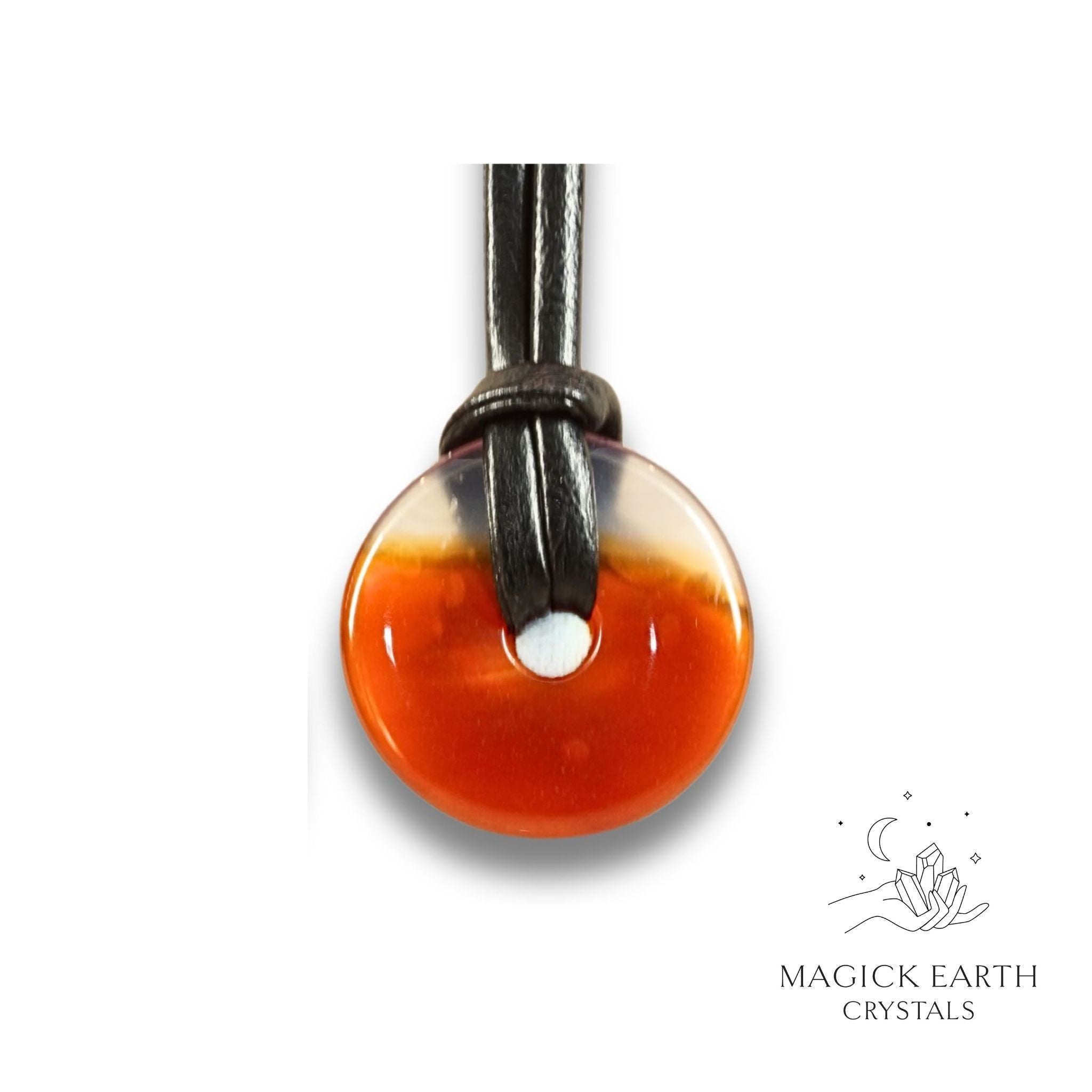 Natural 30mm carnelian donut pendant hanging from a black vegan cord.