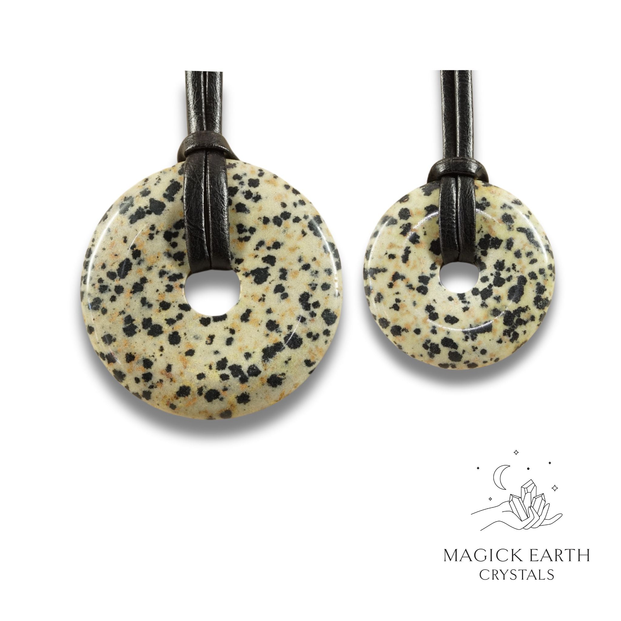 Natural Dalmatian jasper donut pendants in two sizes hanging from black vegan cords arranged left to right from large to small