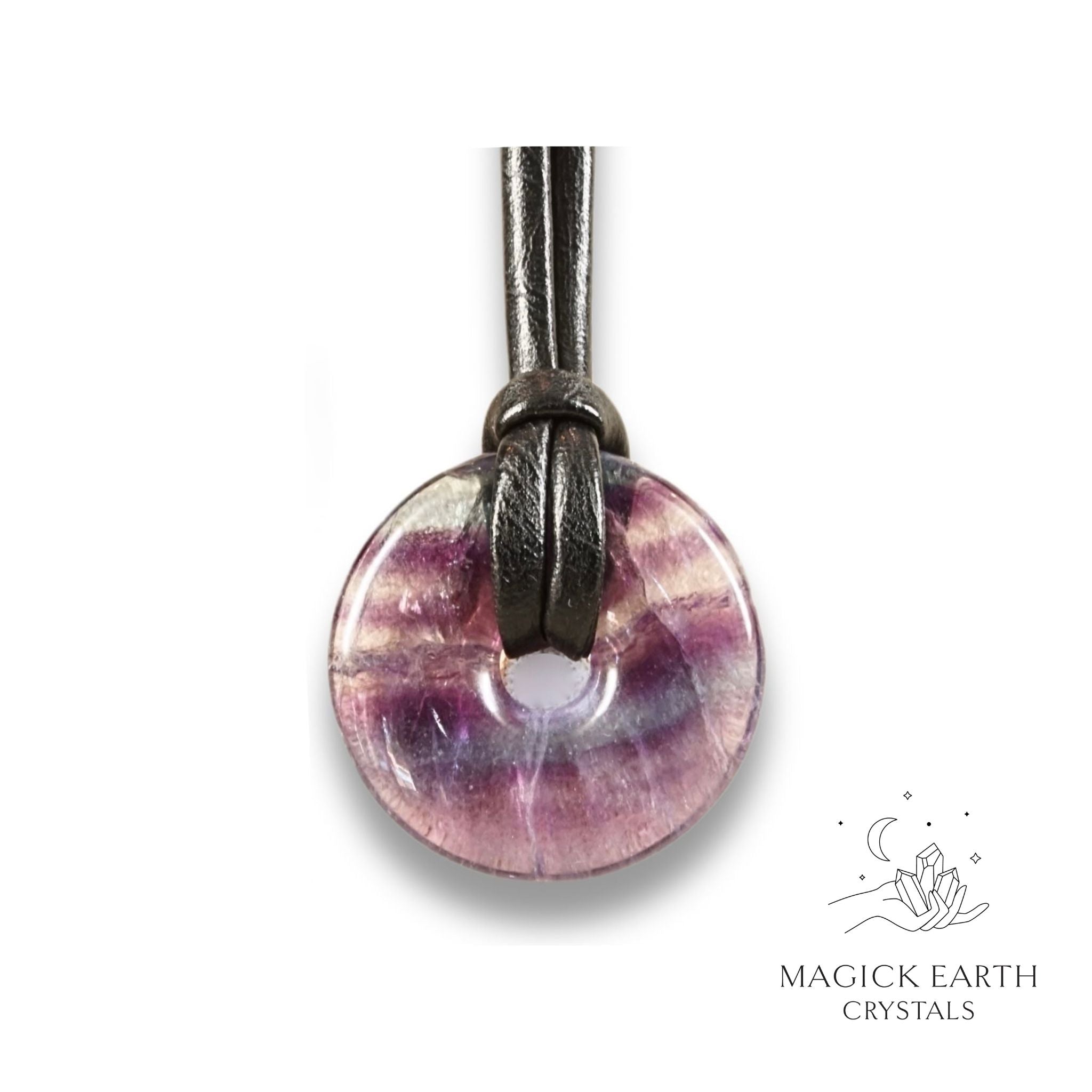 Natural 30mm dark fluorite donut pendant hanging from a black vegan cord.