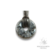 Natural 30mm larvikite donut pendant hanging from a black vegan cord.