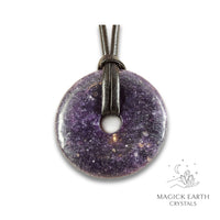 Natural 50mm darker shade lepidolite donut pendant hanging from a black vegan cord.