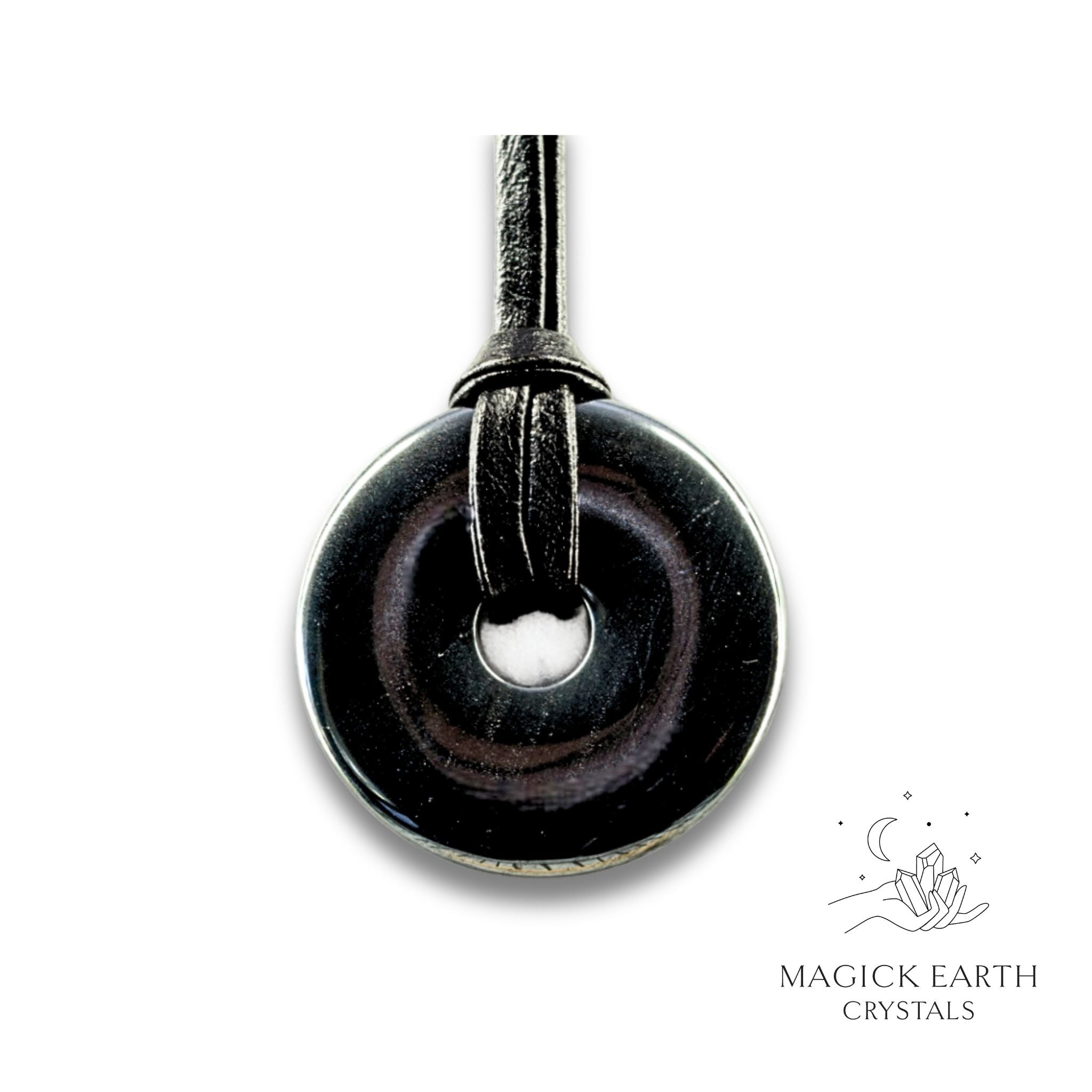 Natural 30mm obsidian donut pendant hanging from a black vegan cord.