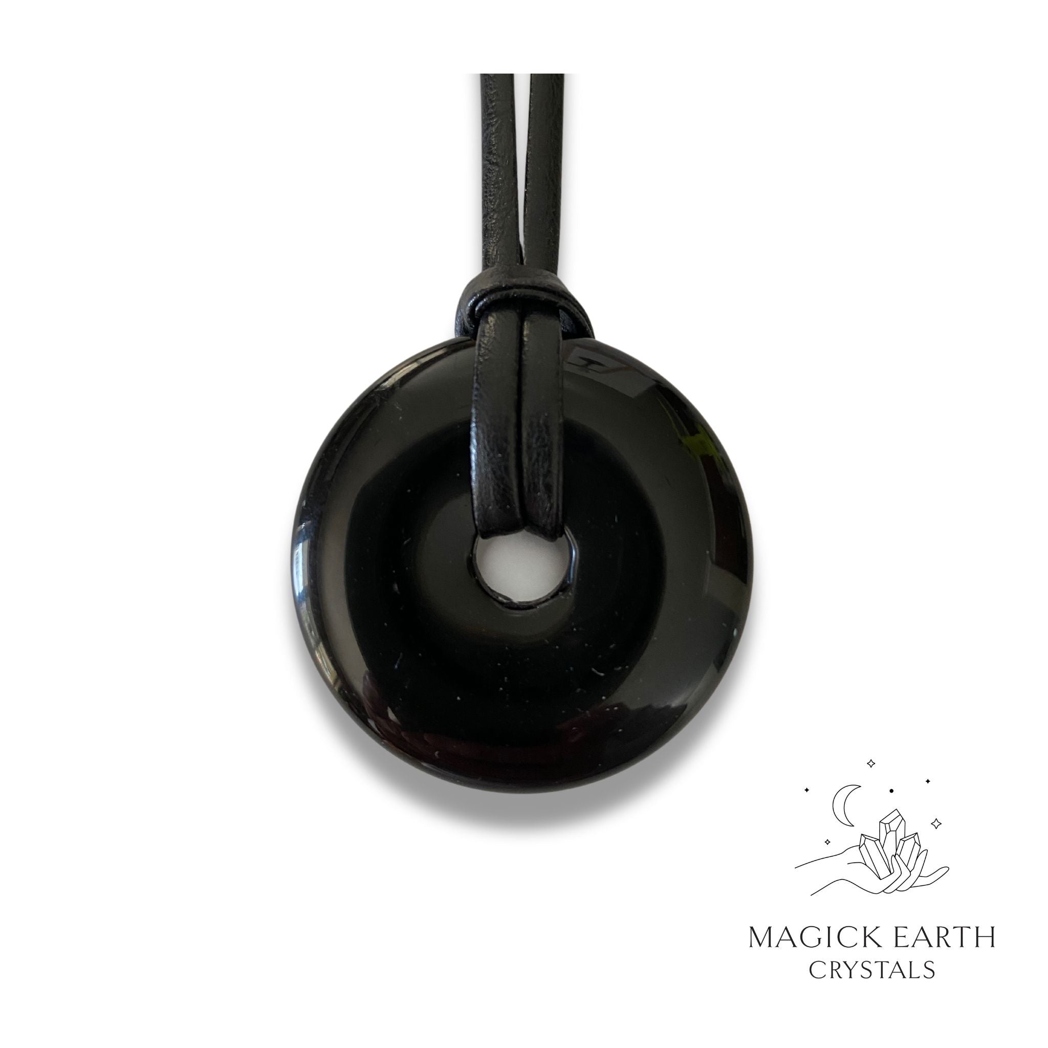 Natural 40mm obsidian donut pendant hanging from a black vegan cord.