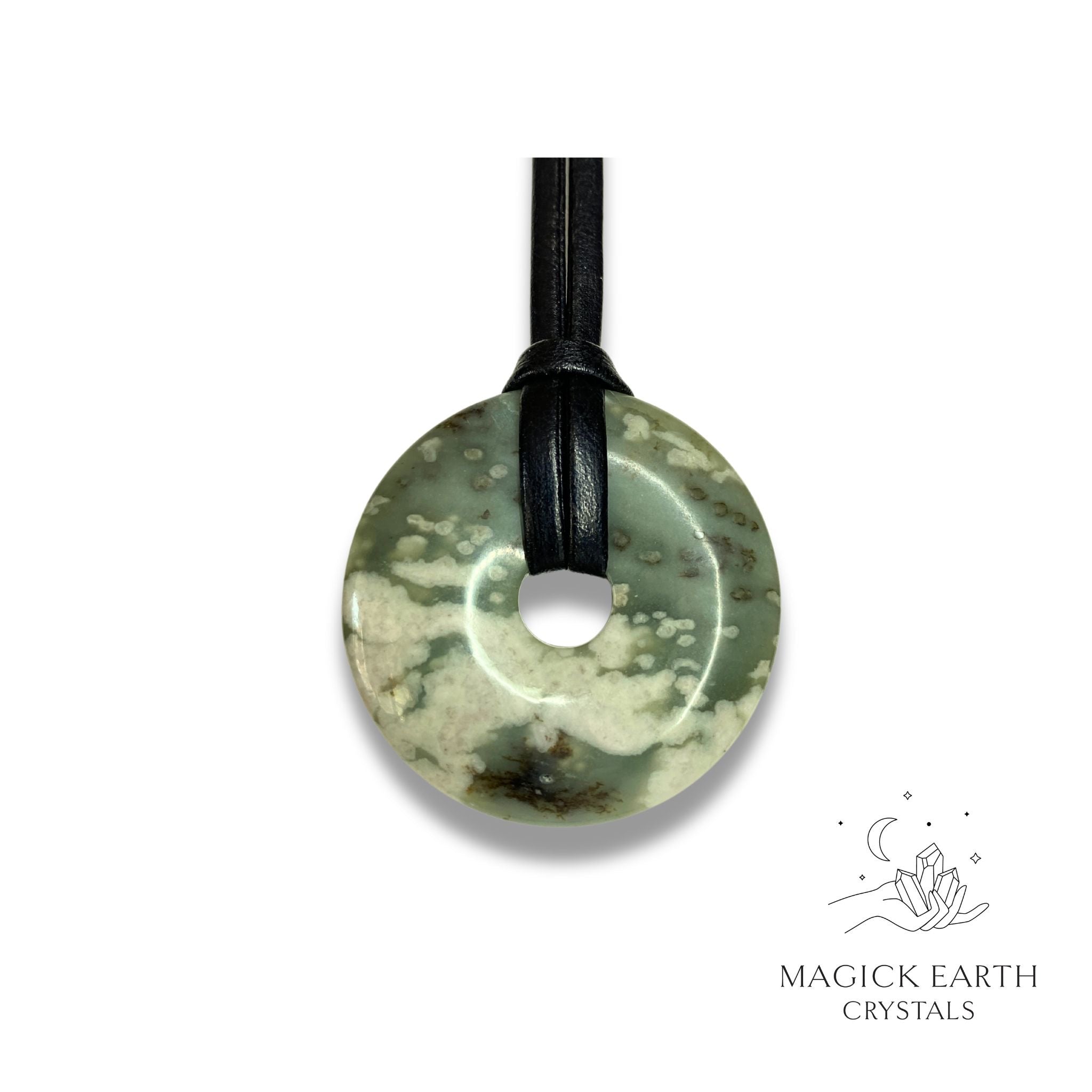 Natural 40mm peace jade donut pendant hanging from a black vegan cord.