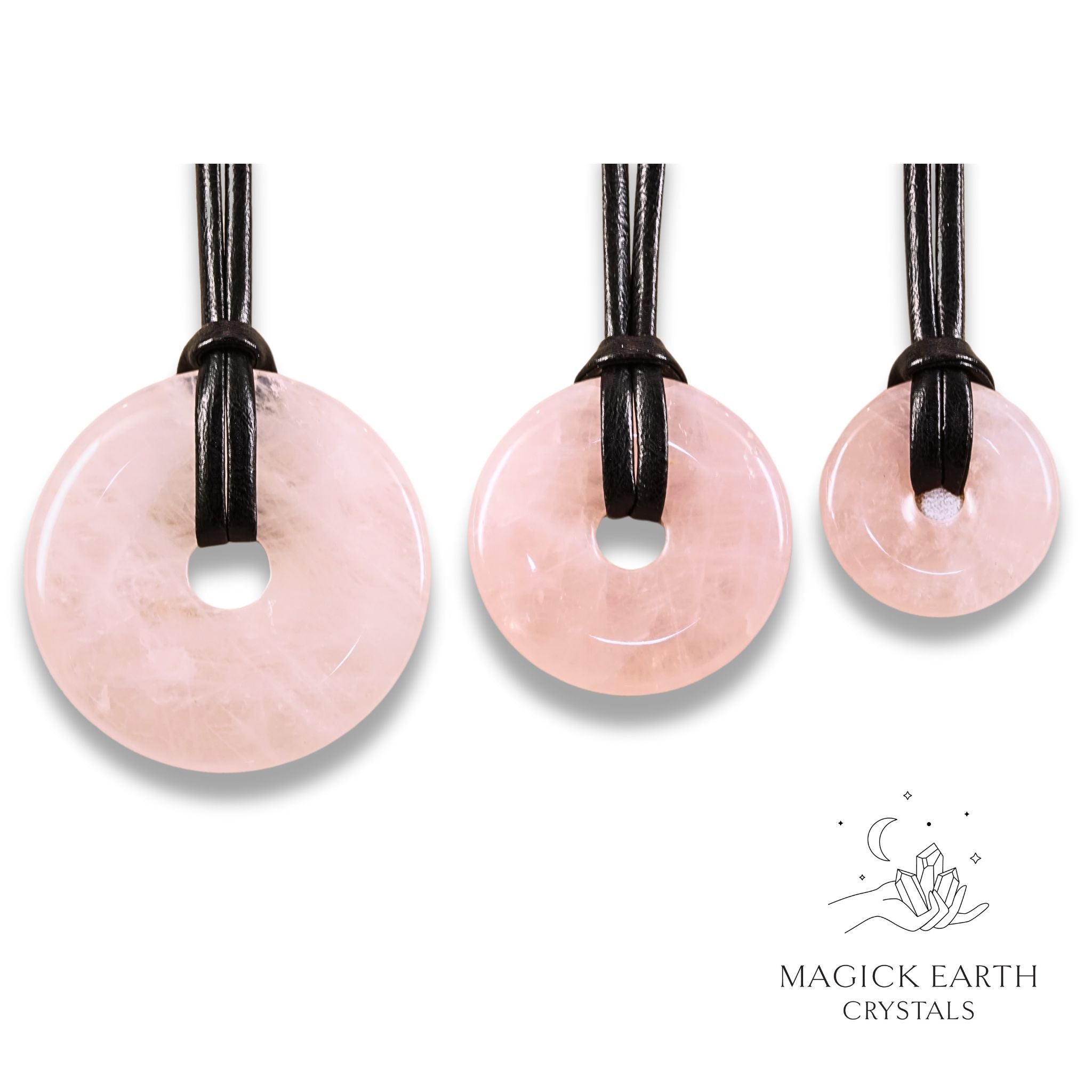 Natural rose quartz donut pendants in three sizes hanging from black vegan cords arranged left to right from large to small