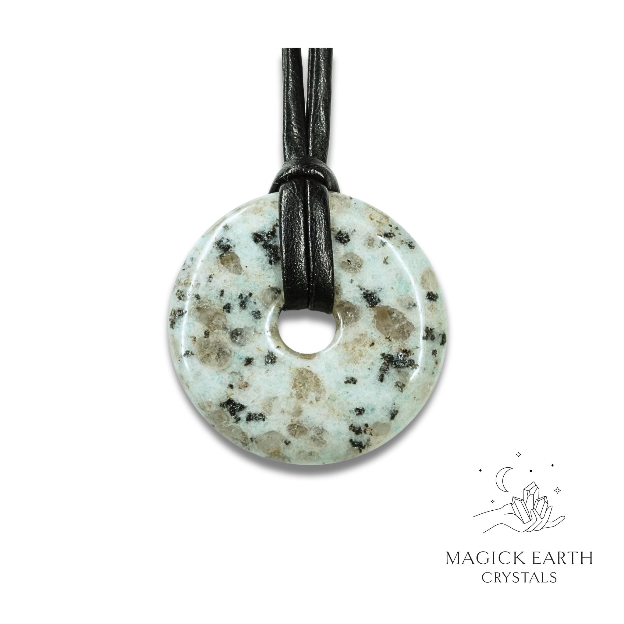 Natural 40mm Sesame Jasper donut pendant hanging from a black vegan cord.