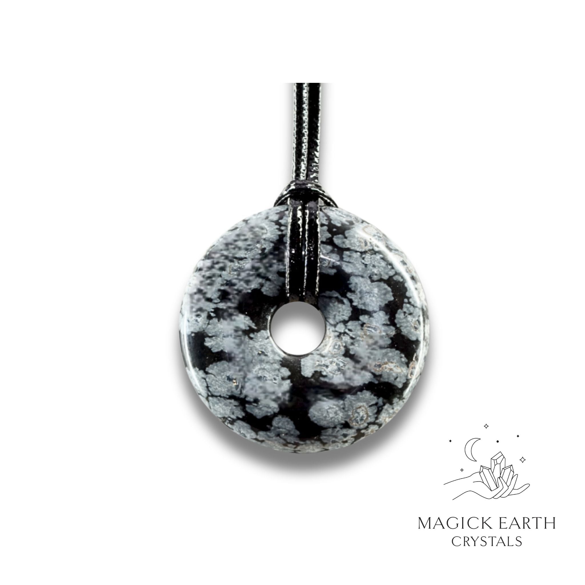 Natural 30mm snowflake obsidian donut pendant hanging from a black vegan cord.