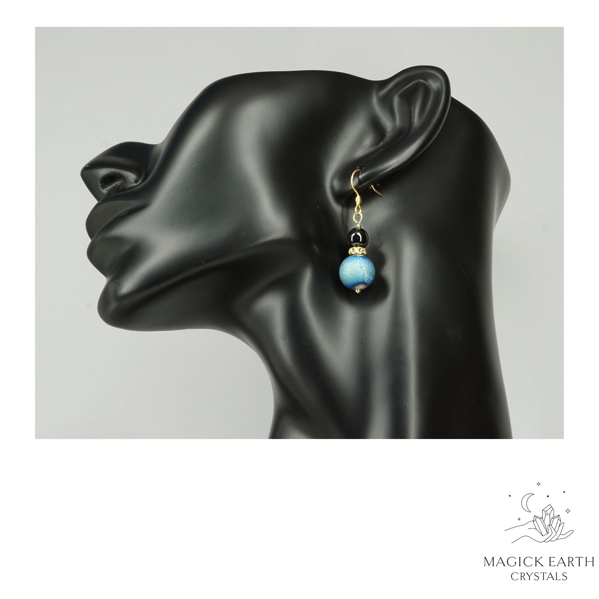Teal Electroplated Druzy Geode and Obsidian Earrings With Gold Finish On Display Head