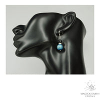 Teal Electroplated Druzy Geode and Obsidian Earrings With Platinum Finish On Display Head
