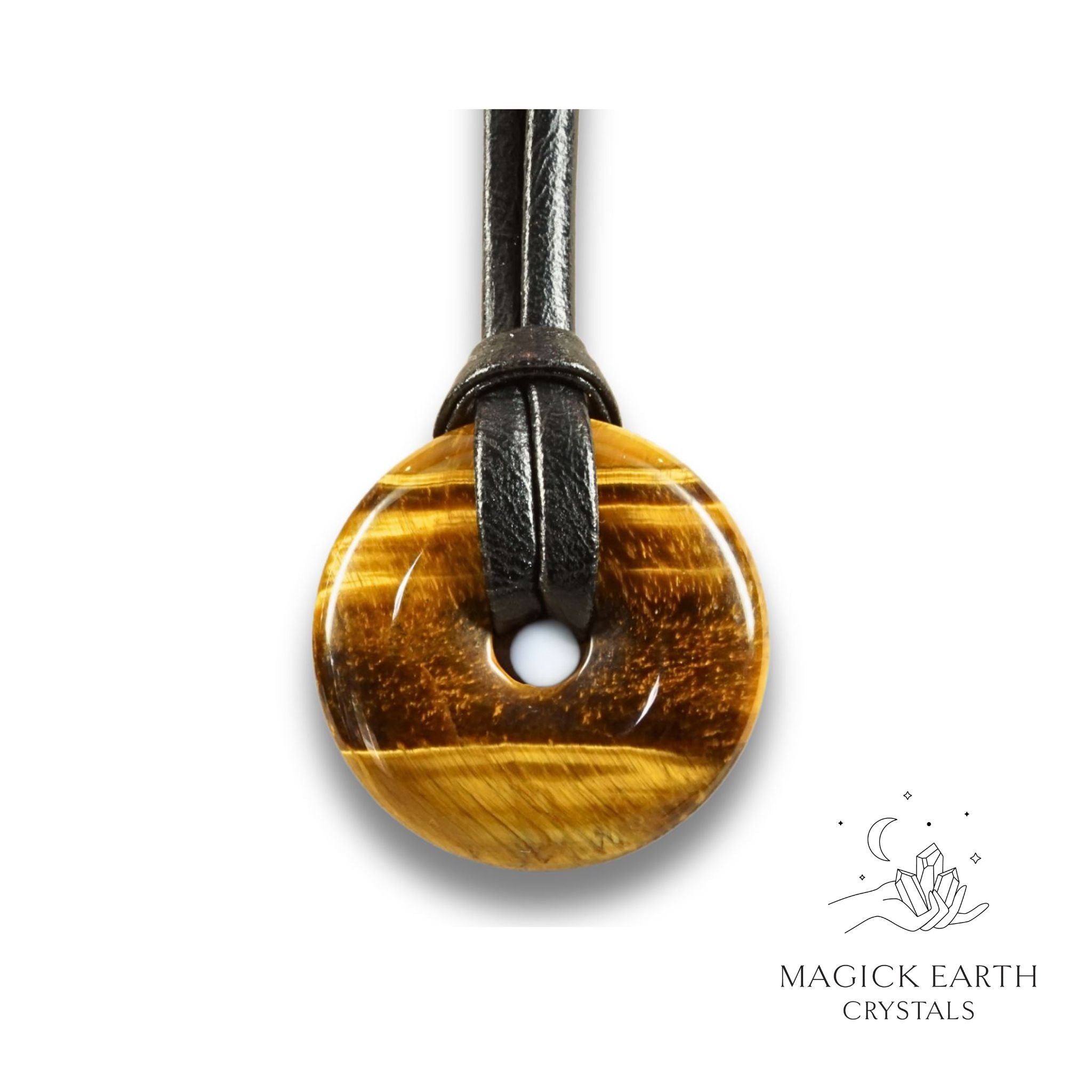 Natural 30mm tiger eye donut pendant hanging from a black vegan cord.