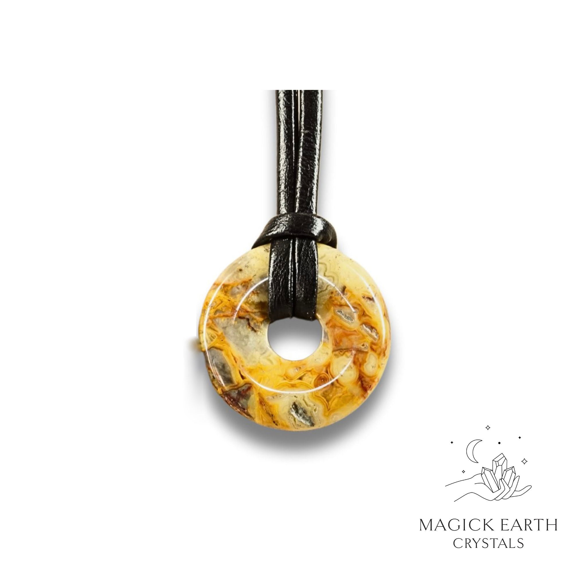 Natural 30mm yellow shade crazy agate donut pendant hanging from a black vegan cord.