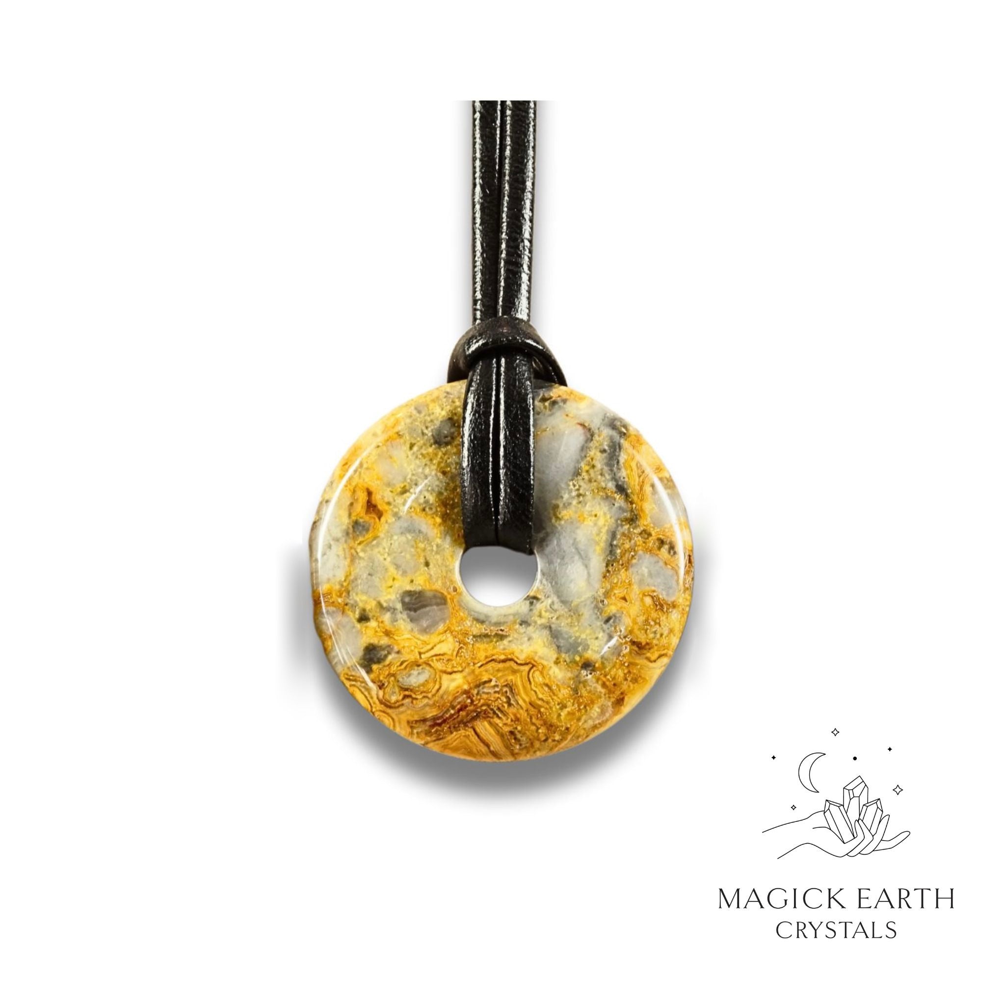 Natural 40mm yellow shade crazy agate donut pendant hanging from a black vegan cord.