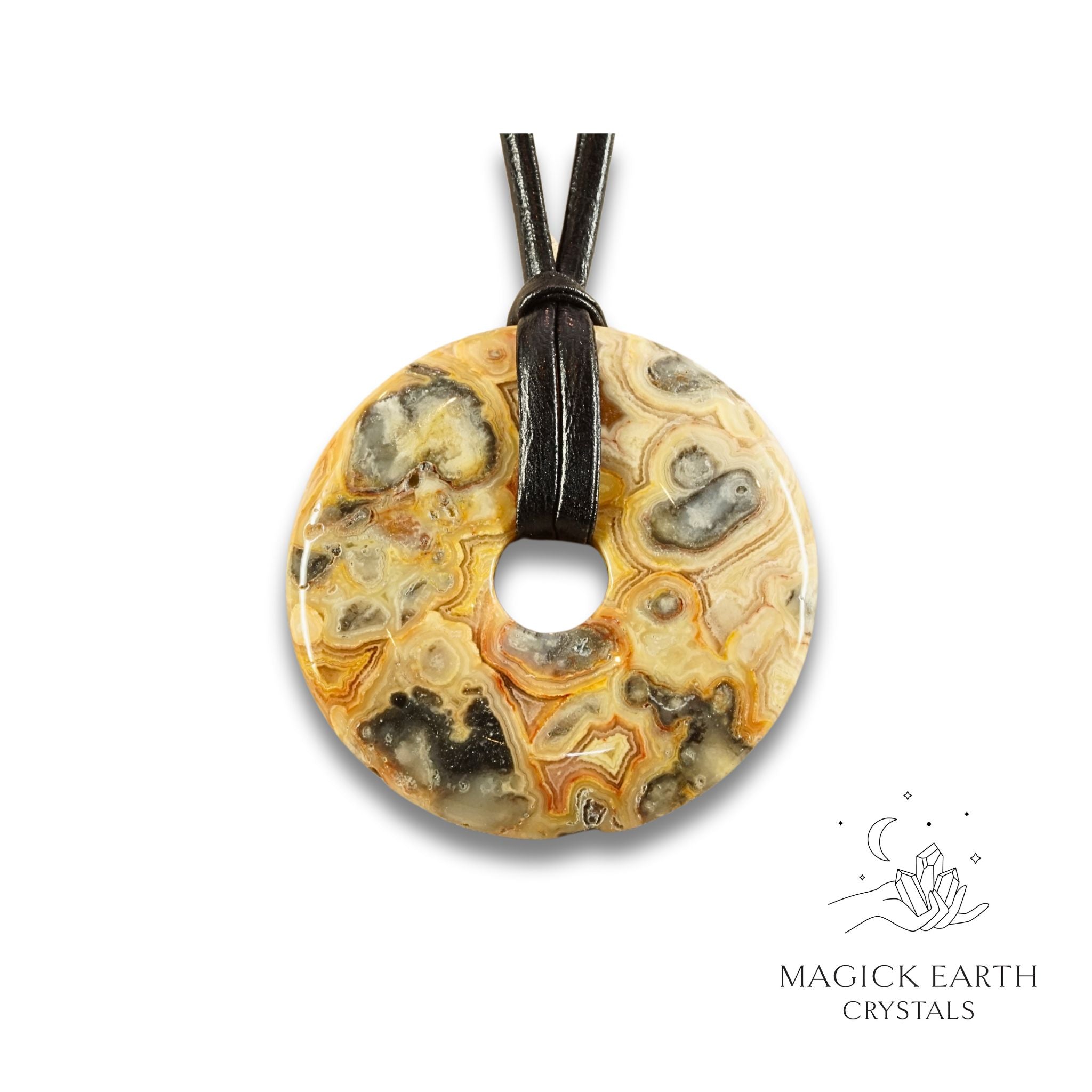Natural 50mm yellow shade crazy agate donut pendant hanging from a black vegan cord.