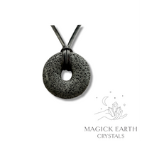 Natural charcoal lava donut pendant hanging from a black vegan cord.