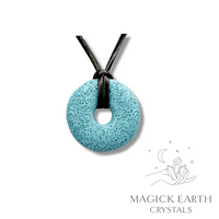 Natural light blue lava donut pendant hanging from a black vegan cord.
