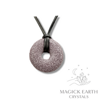 Natural purple lava donut pendant hanging from a black vegan cord.
