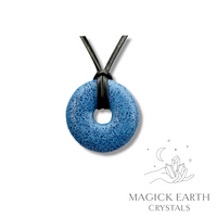 Natural royal blue lava donut pendant hanging from a black vegan cord.
